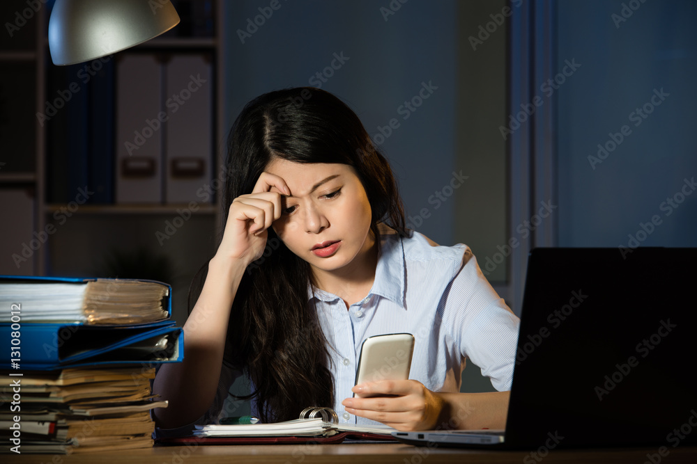 asian business woman text message by smartphone overtime working