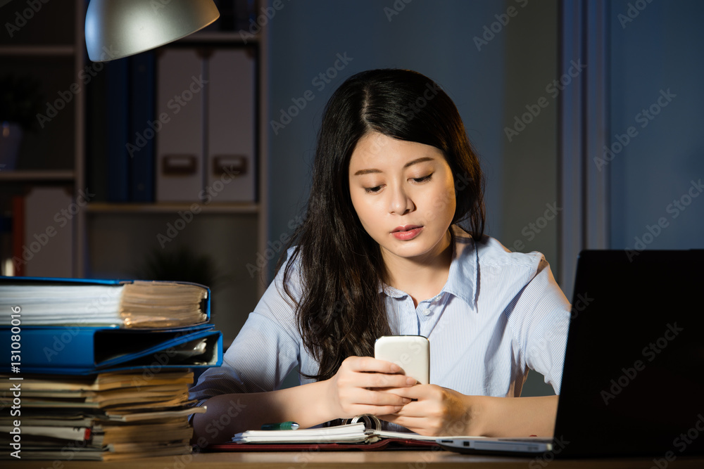 asian business woman text message by smartphone overtime working