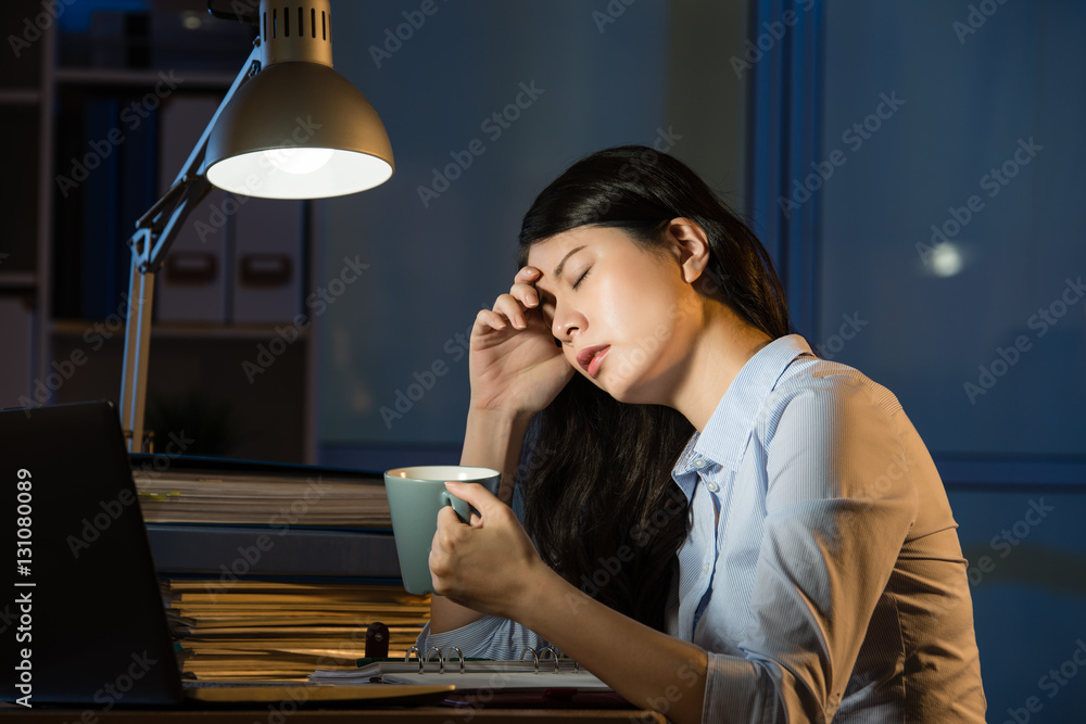 asian business woman drink coffee refreshing working overtime la