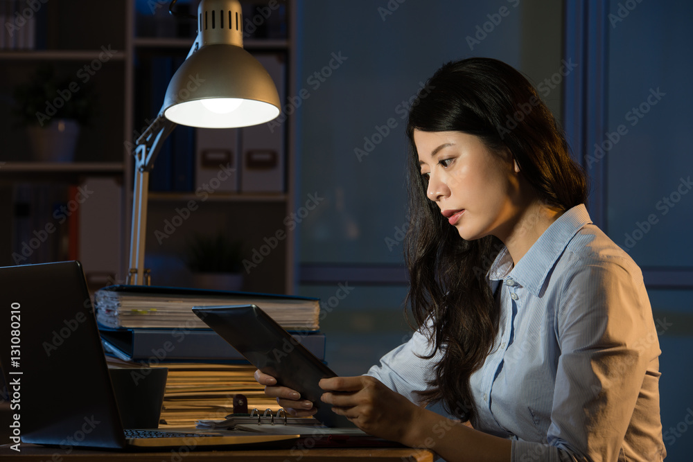 asian business woman use digital tablet working late overtime