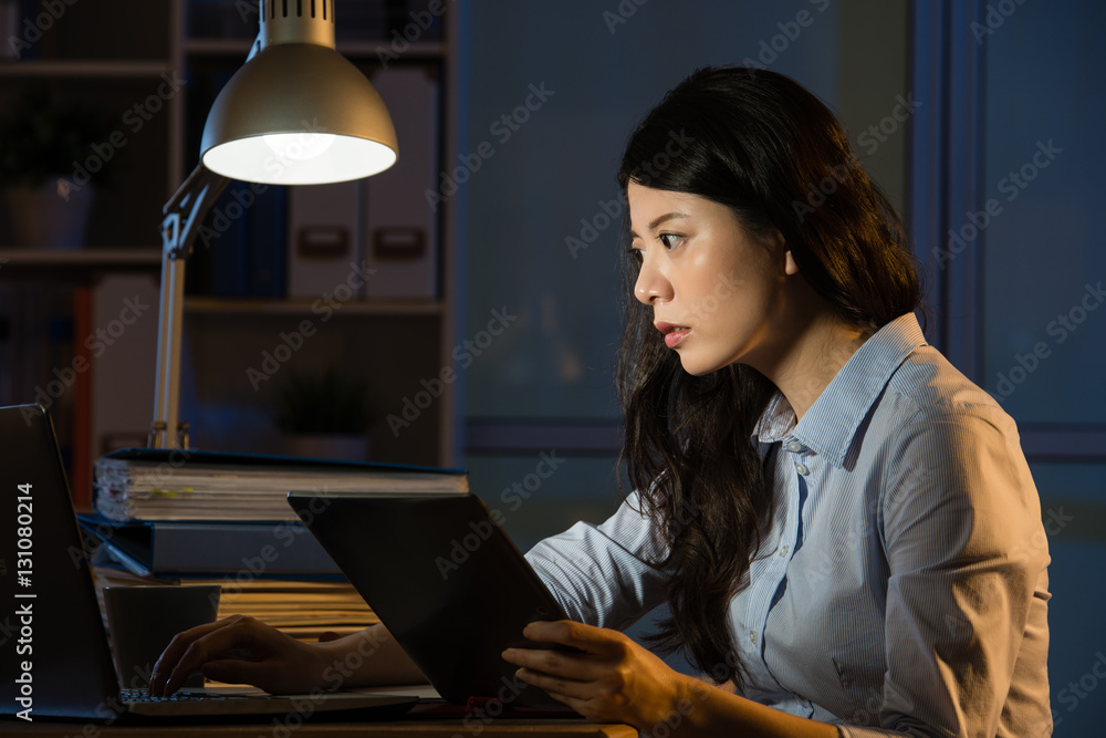 asian business woman use digital tablet working late overtime