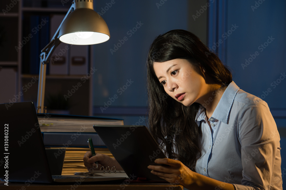 asian business woman use digital tablet working late overtime