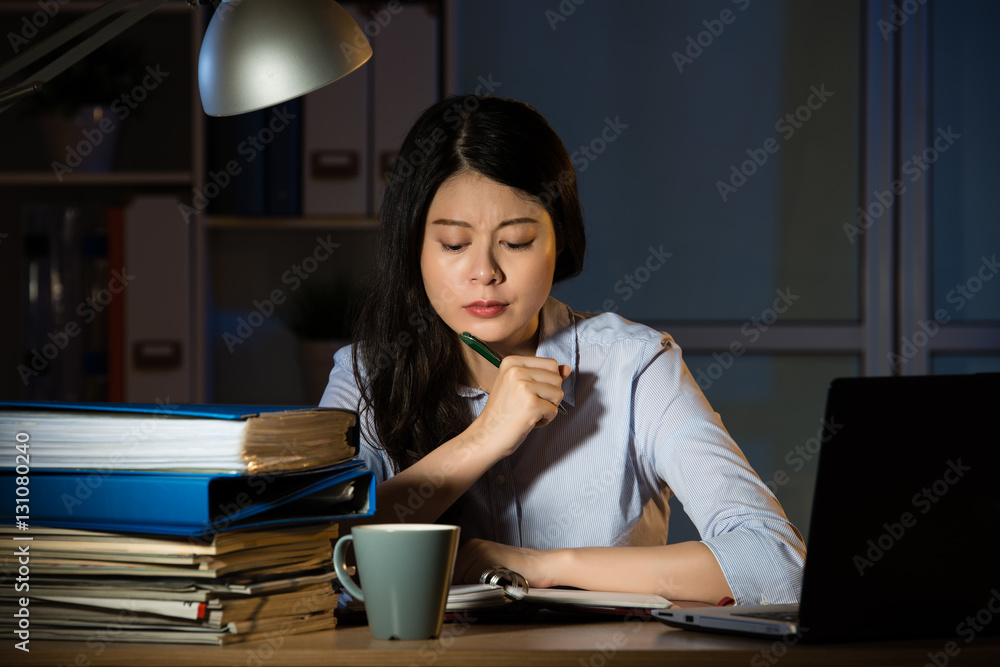 asian business woman working overtime late night in office