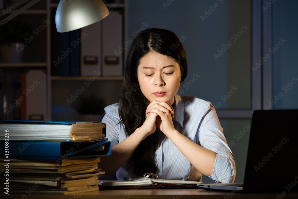 asian business woman thinking and working overtime late night