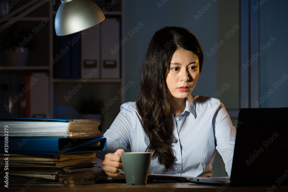 asian business woman drink coffee working overtime late night