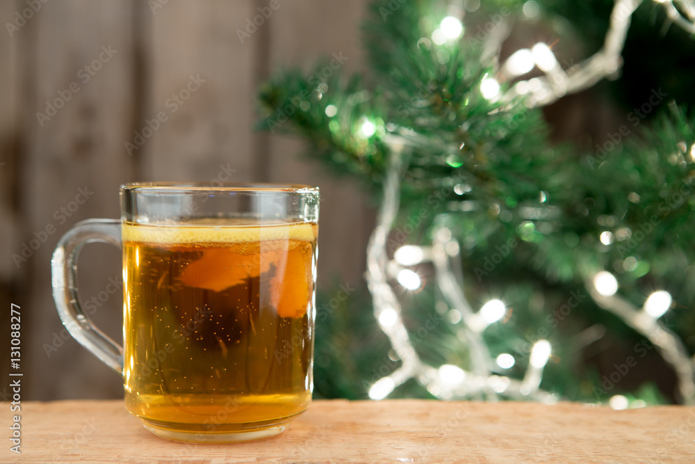 Ginger tea in a cup on wooden background