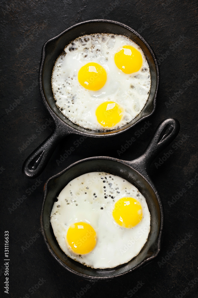 Pans with fried eggs