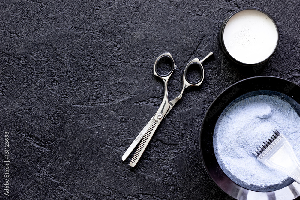 hair dye with brush on dark background top view