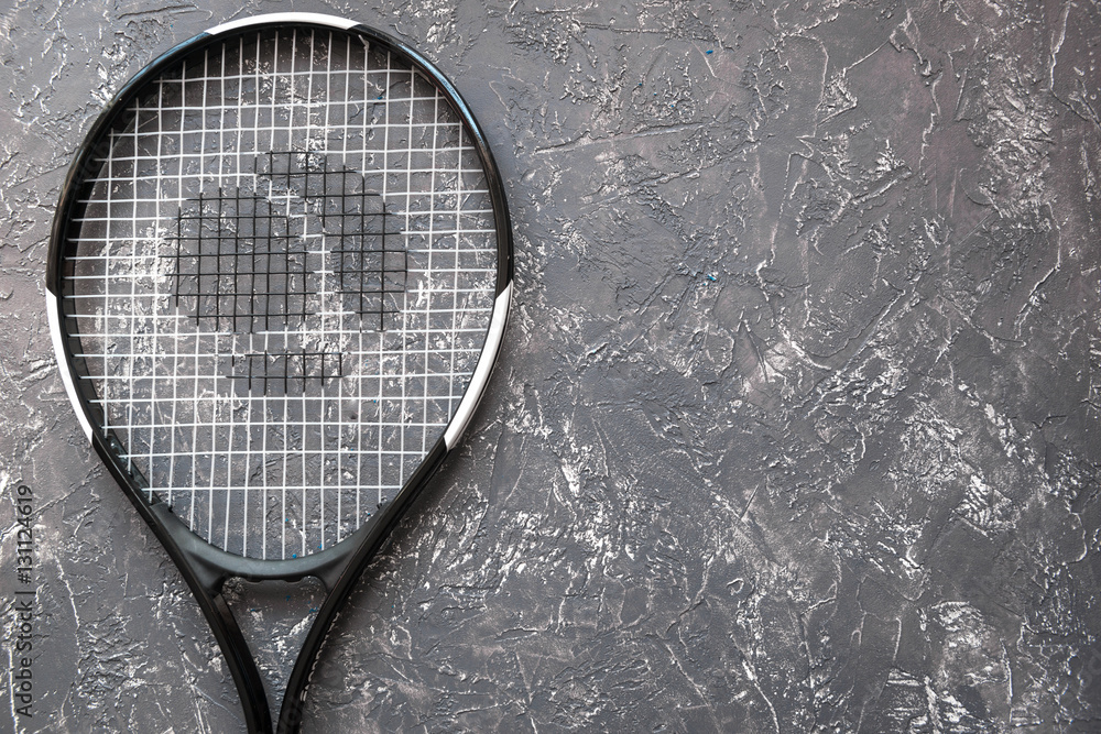 tennis racket on gray background top view