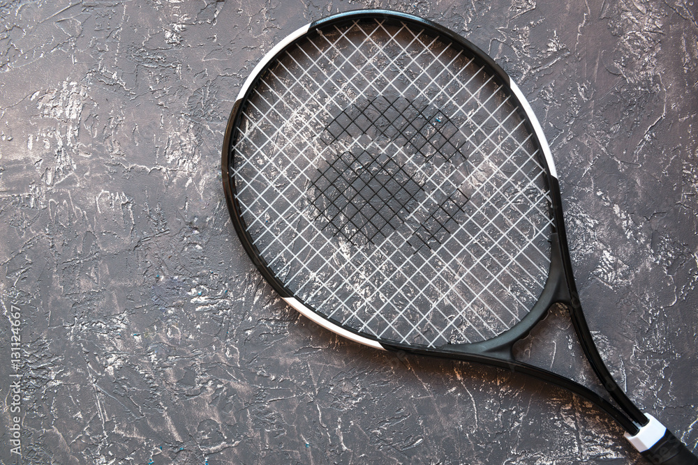 tennis racket on gray background top view