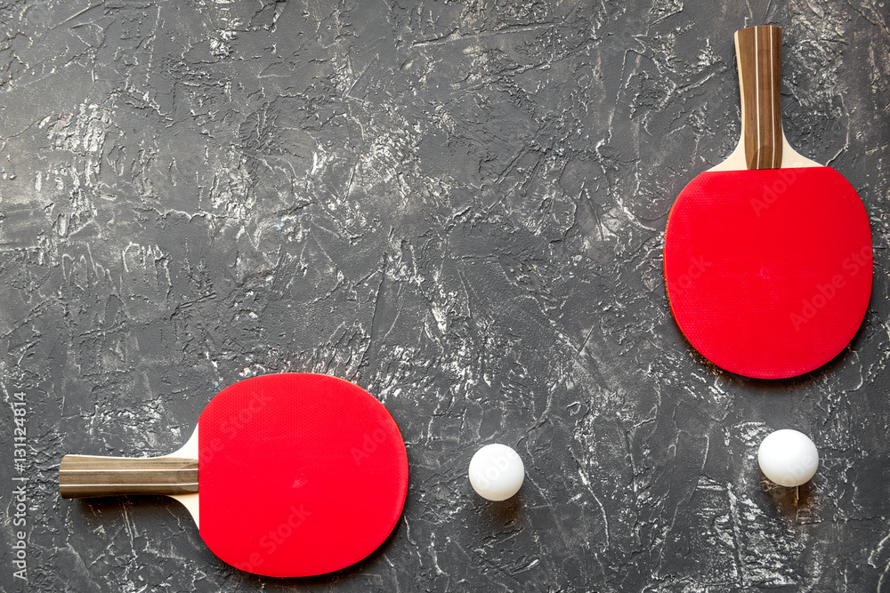 Red racket for ping pong ball gray background top view