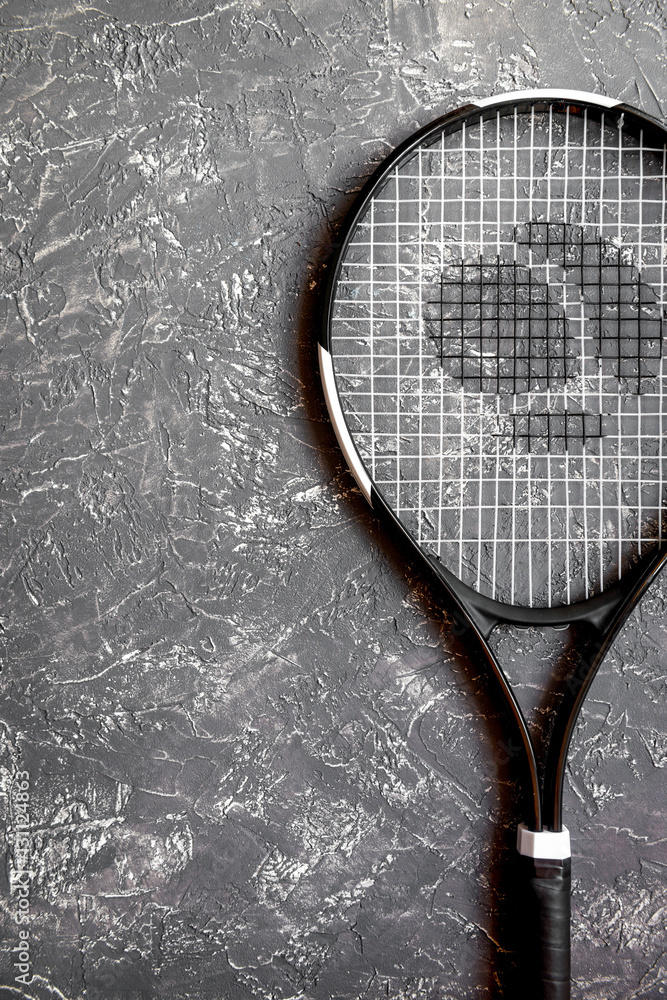 tennis racket on gray background top view