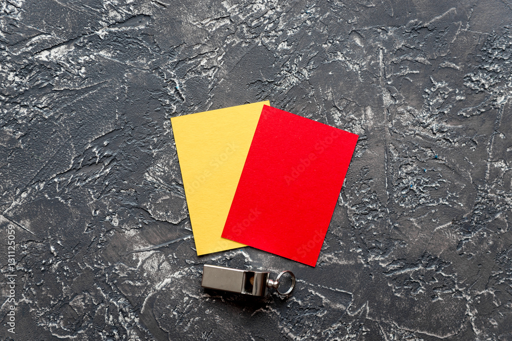 red and yellow cards on dark background top view