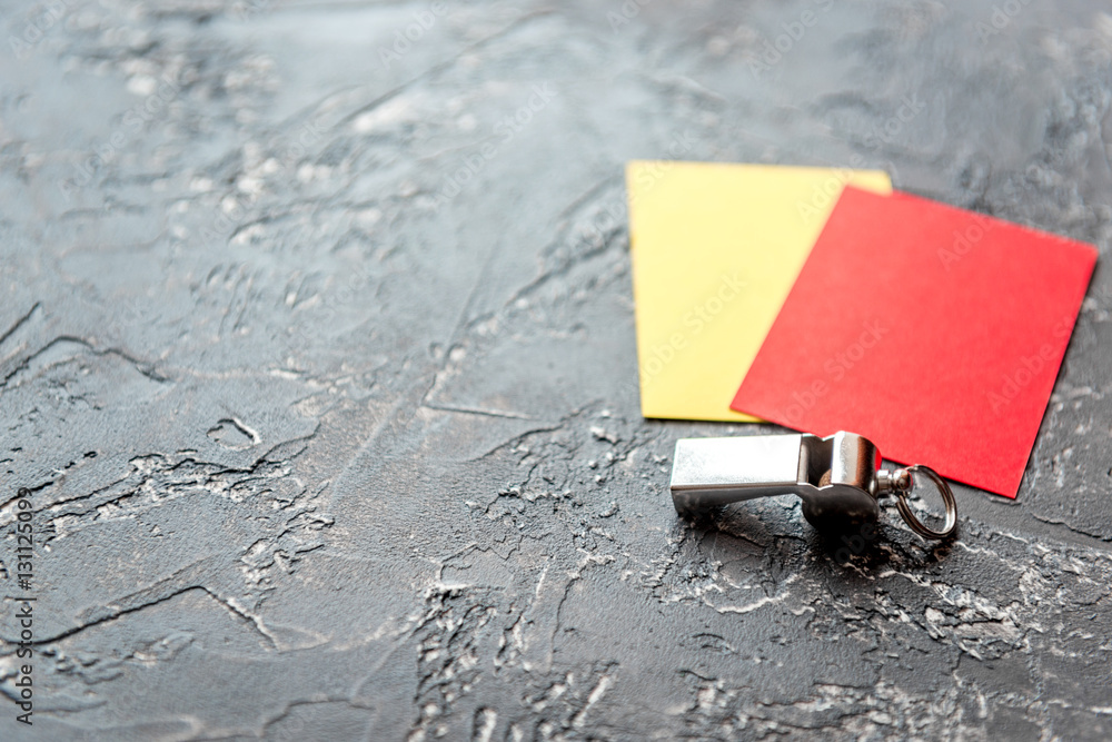 red and yellow cards on dark background close up