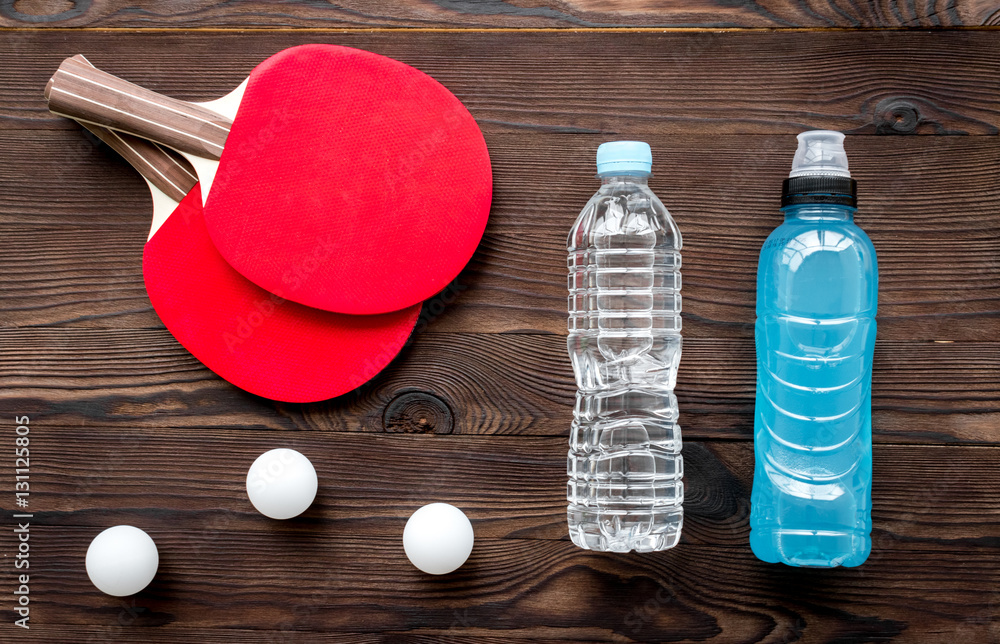 tennis racquet - fitness in the wooden background top view