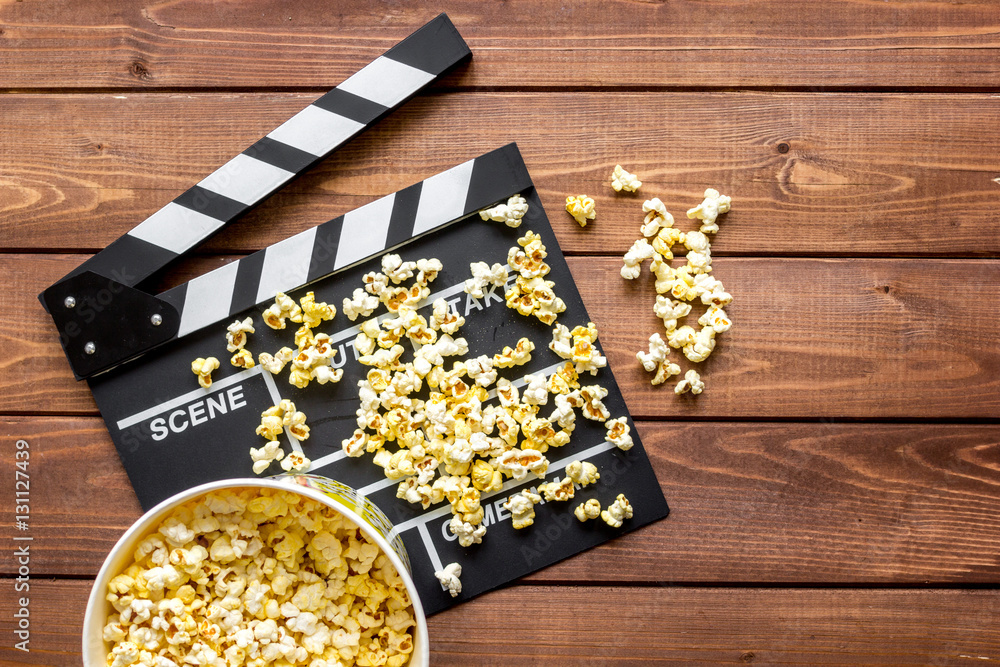 watching movie with popcorn on wooden background top view