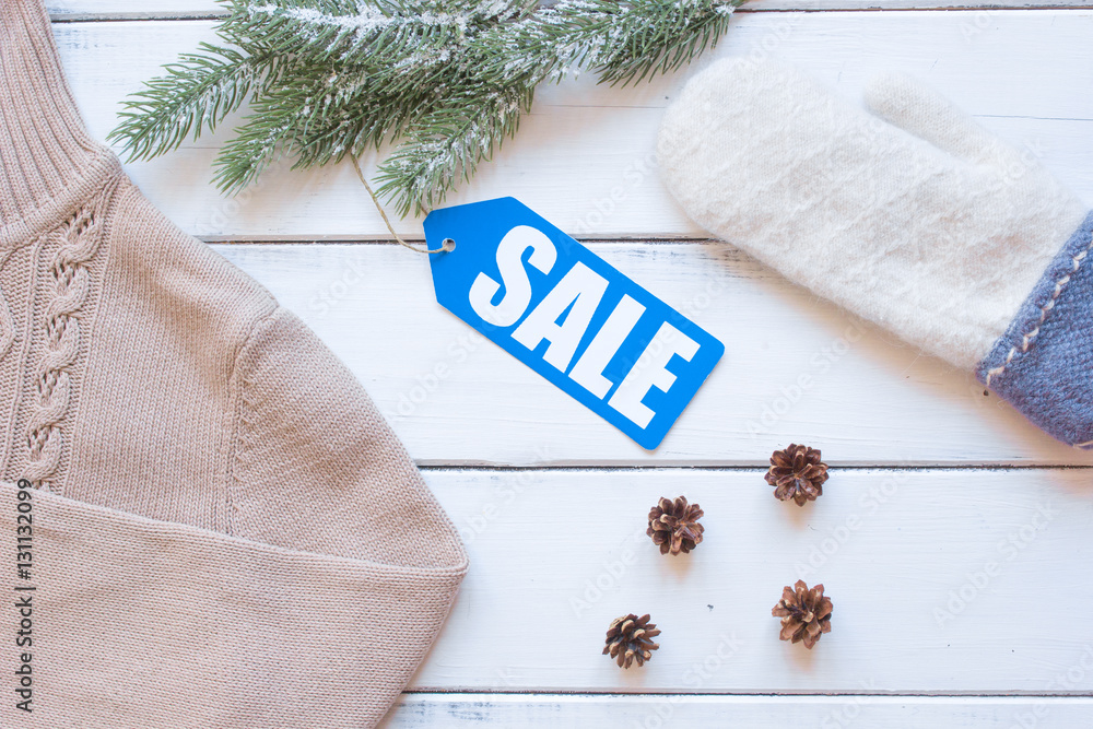 winter clothing sale on wooden background top view