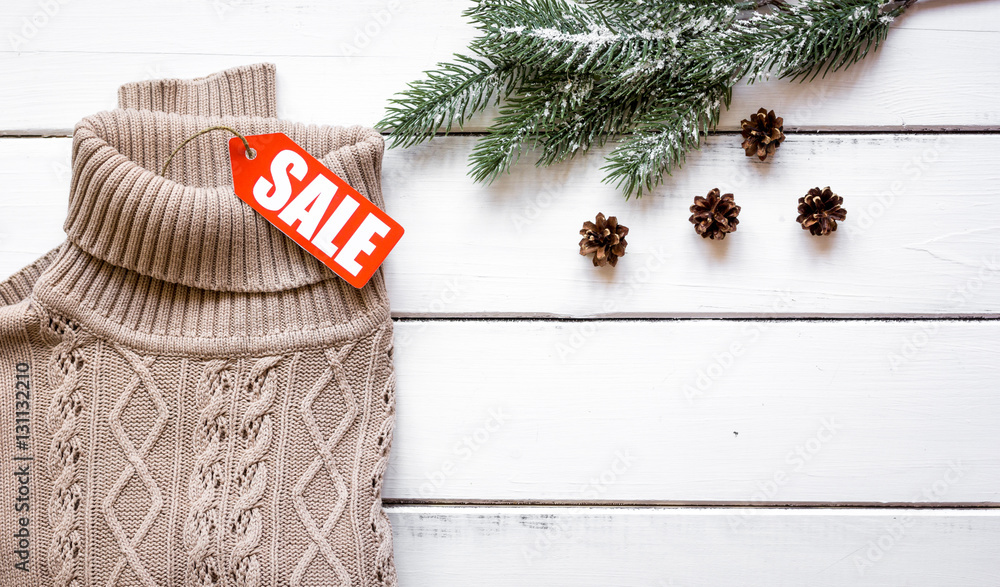 Christmas clothing sale on wooden background top view