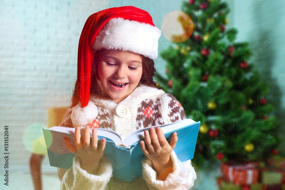 Surprised child opening book.