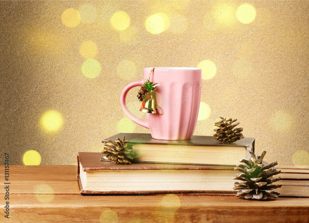 Christmas tea mug on books.