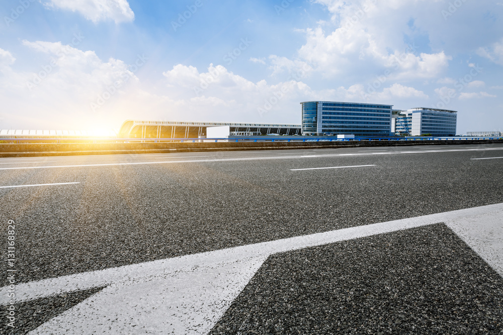 Asphalt road at the airport at sunset