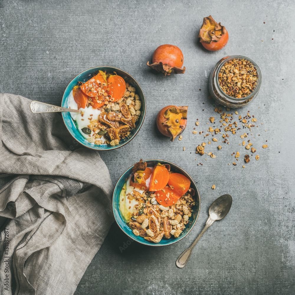 Healthy vegetarian breakfast. Oatmeal, quinoa granola with yogurt, dried fruit, seeds, honey, persim