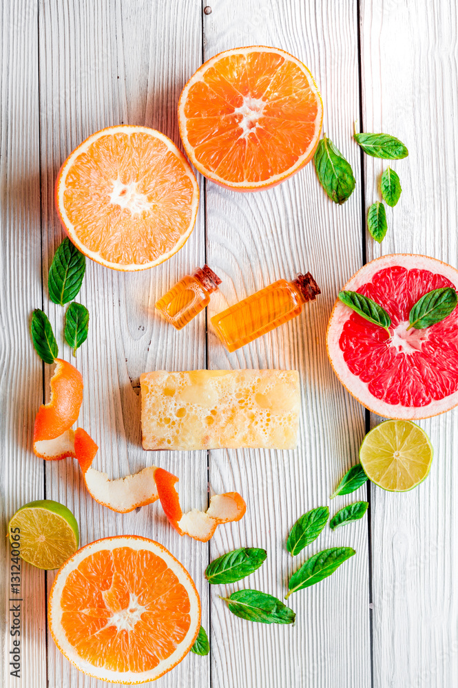 organic cosmetic with citrus on wooden background top view