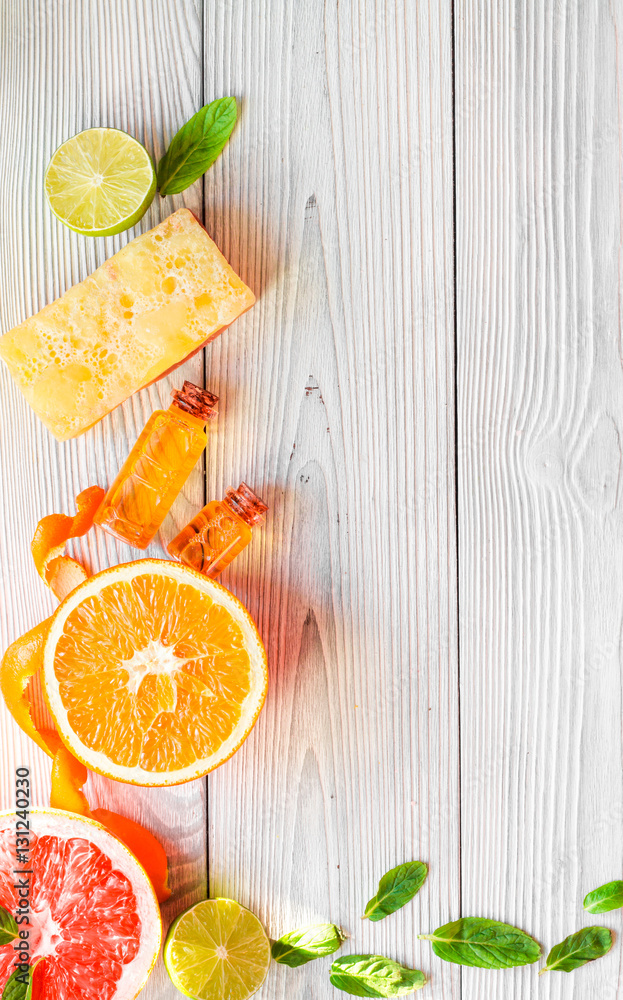 organic cosmetic with citrus on wooden background top view