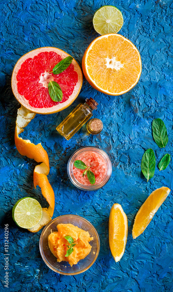 organic cosmetic with citrus on blue background top view