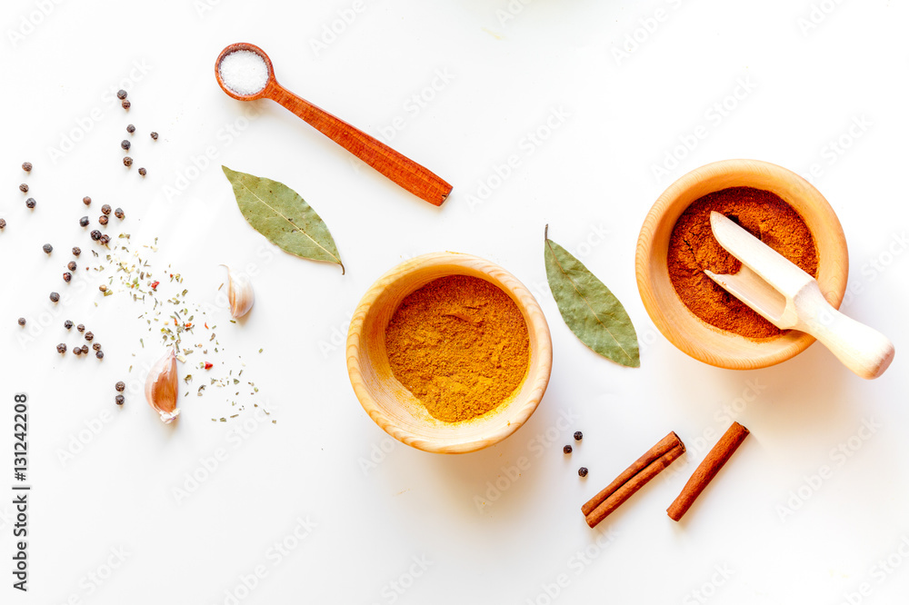 spices in wooden bowl white background top view