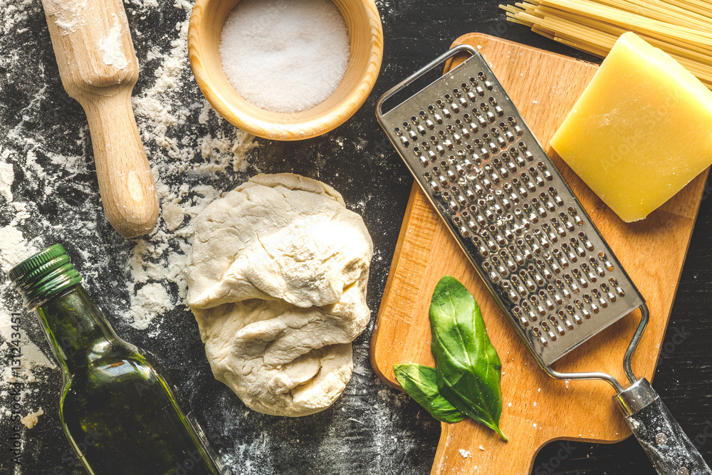 cooking process of pasta on dark background top view