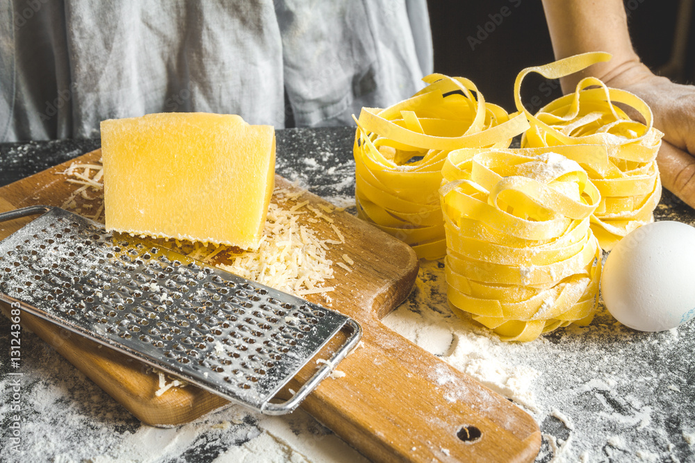 cooking pasta by chef in kitchen on dark background