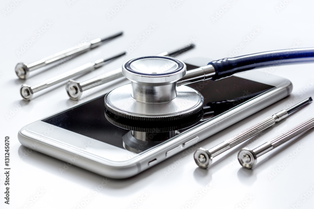 diagnostic of gadgets on white background with stethoscope