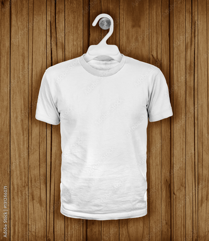 White T-shirt hanging on a wooden wall