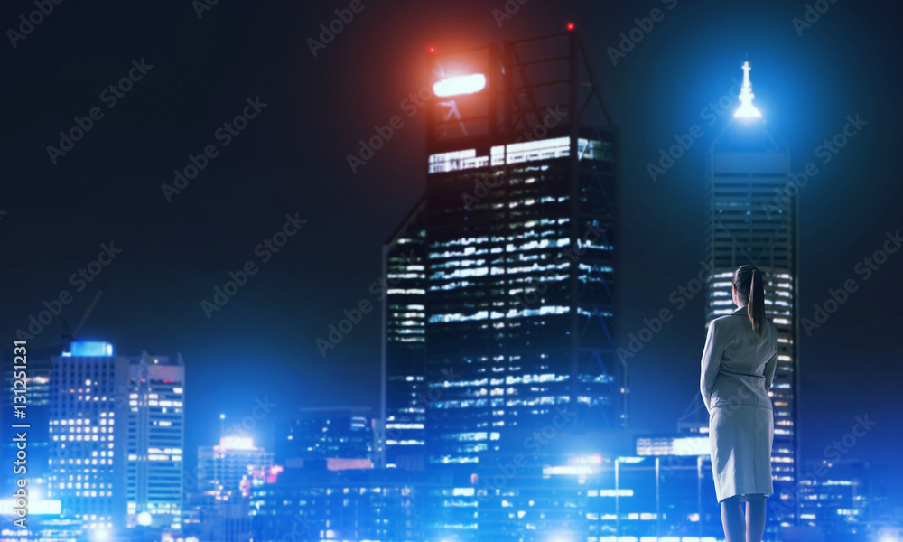 Woman looking at night city