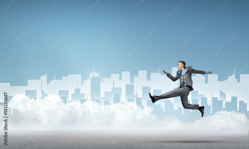 Businessman jumping high