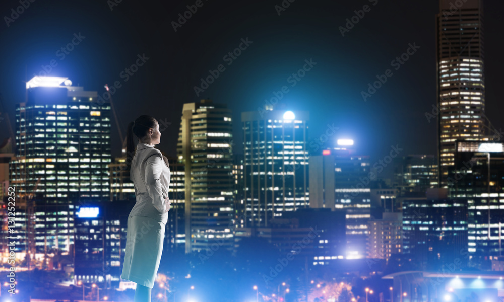 Woman looking at night city