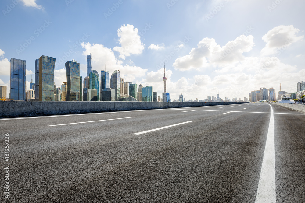 Asphalt road and modern skyline and buildings in Shanghai