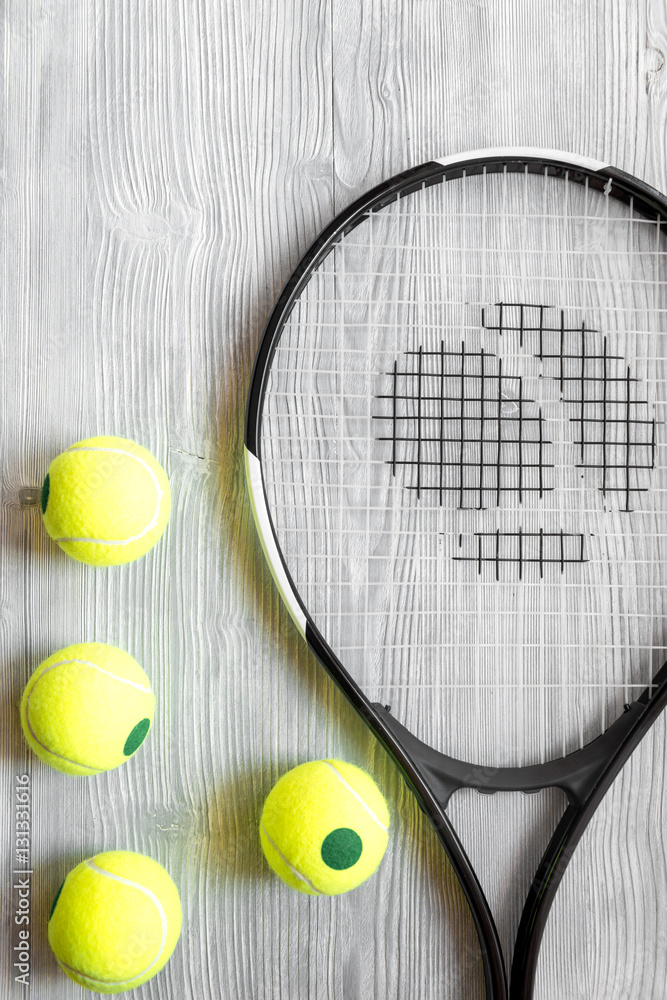 tennis racket on wooden background top view