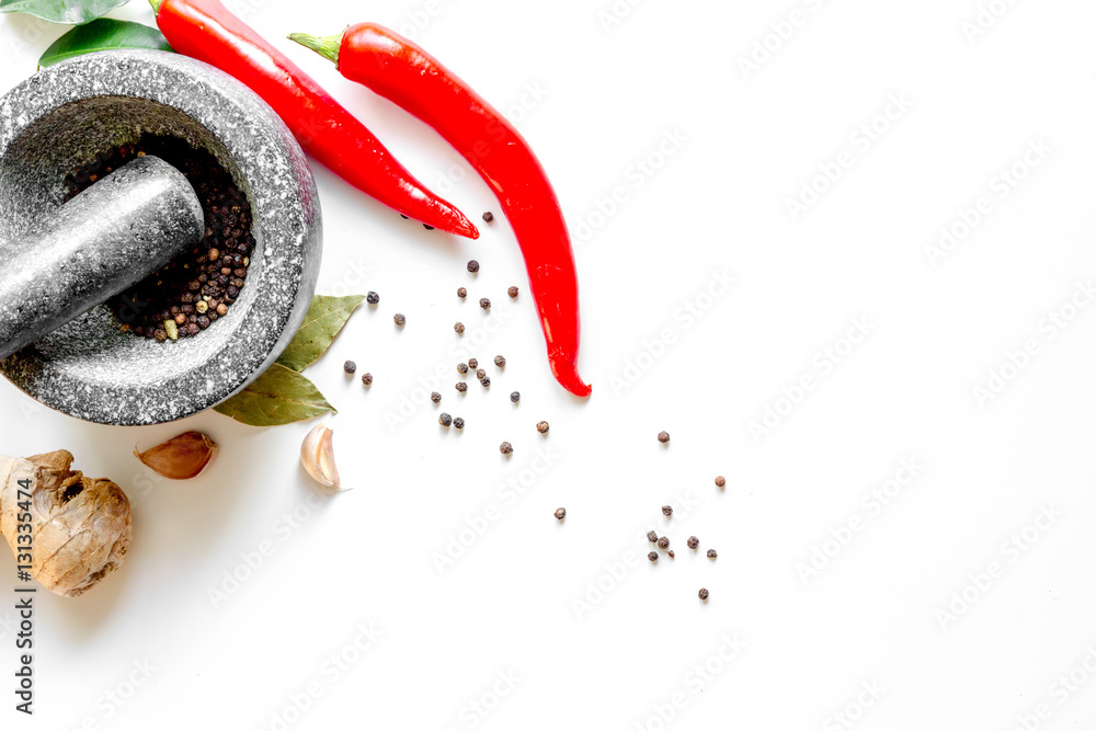 spices and stone mortar white background top view mock up