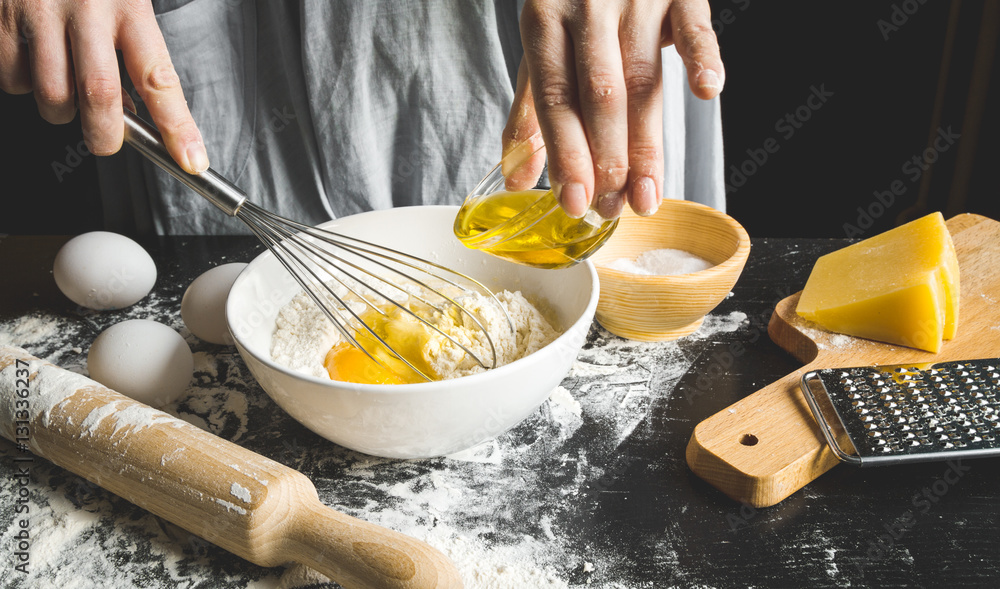 cooking pasta by chef in kitchen on dark background