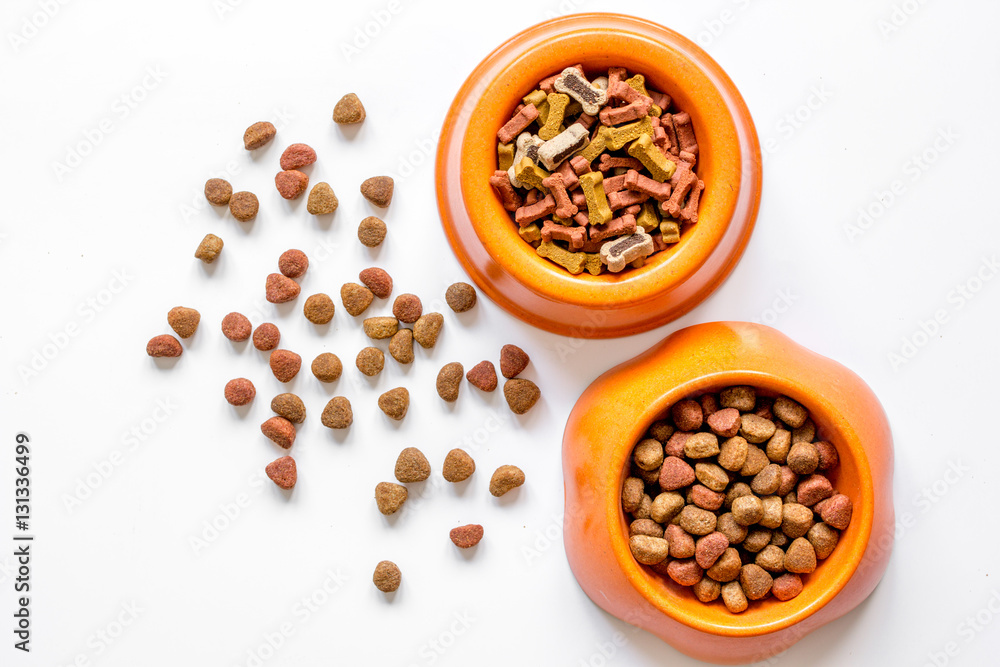 dry pet food in bowl on white background top view