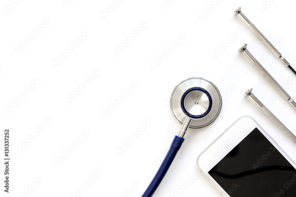 diagnostic of gadgets on white background with stethoscope top view