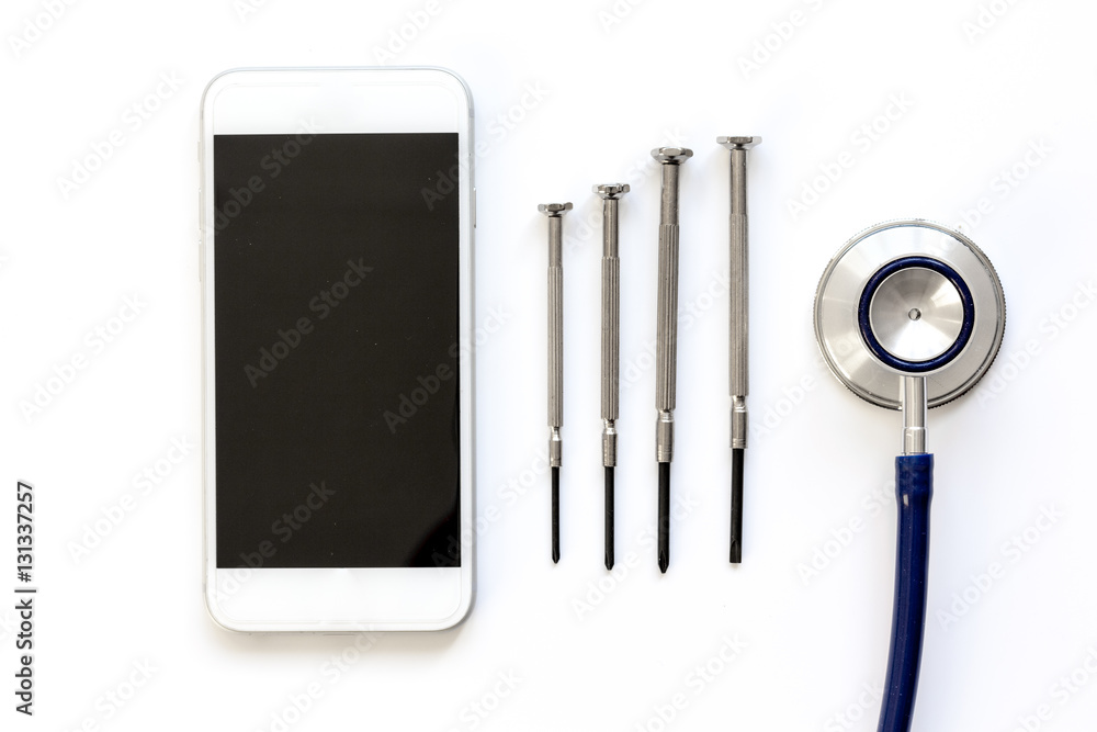 diagnostic of gadgets on white background with stethoscope top view