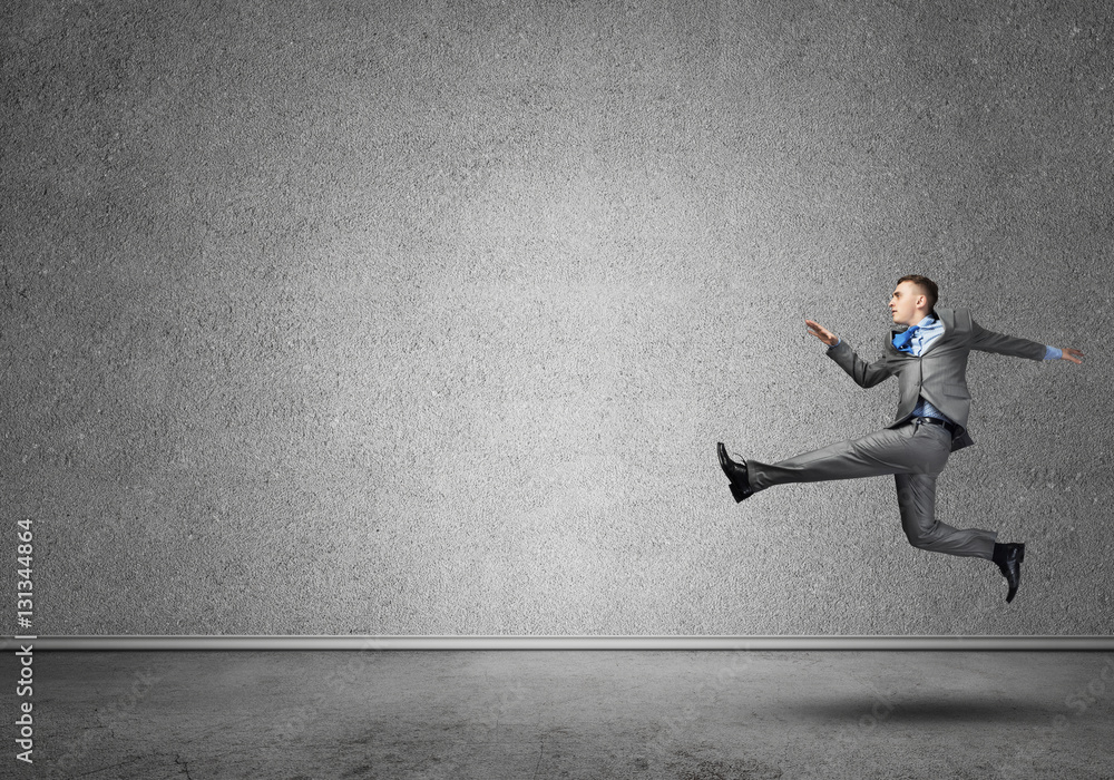 Businessman jumping high