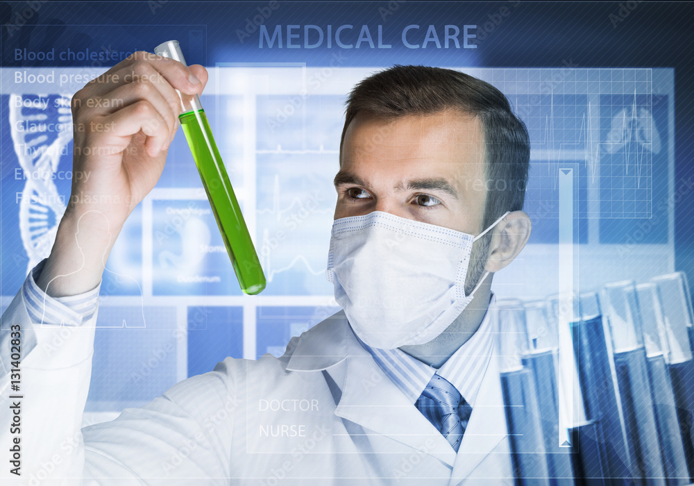 Portrait of concentrated male scientist working with reagents in laboratory