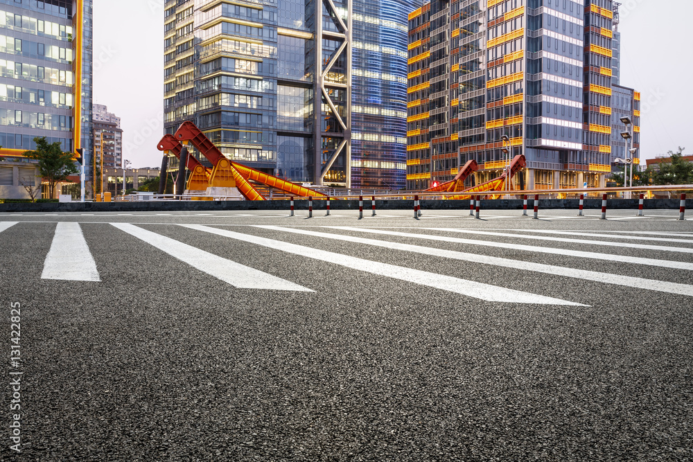 Asphalt road and modern cityscape at night in Shanghai