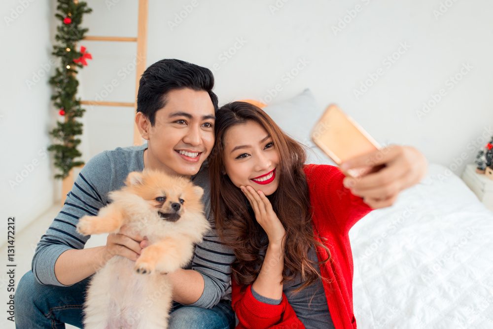 Christmas Asian Couple.Happy Smiling Family at home celebrating.