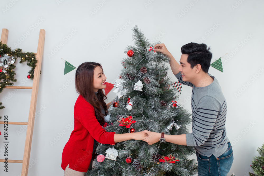 Christmas Asian Couple.Happy Smiling Family at home celebrating.