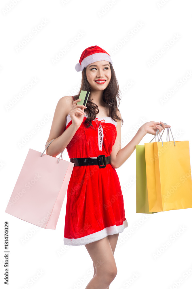 Smiling woman holding shopping bags before christmas showing cre